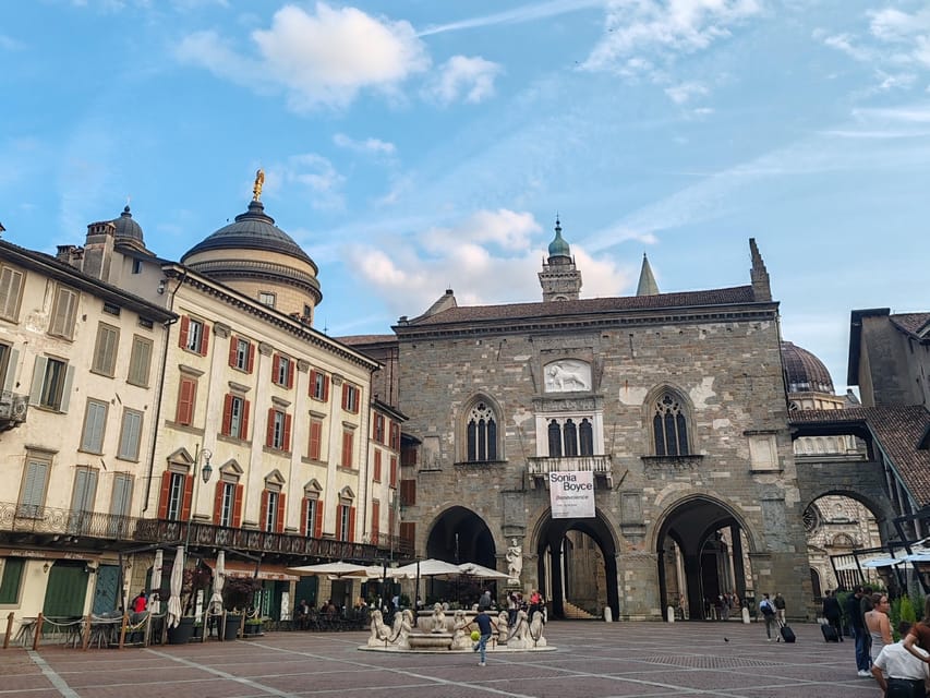 Bergamo: Upper Town Guided Tour with French-speaking Guide - Piazza Vecchia and Piazza Duomo: Bergamo’s political and religious core