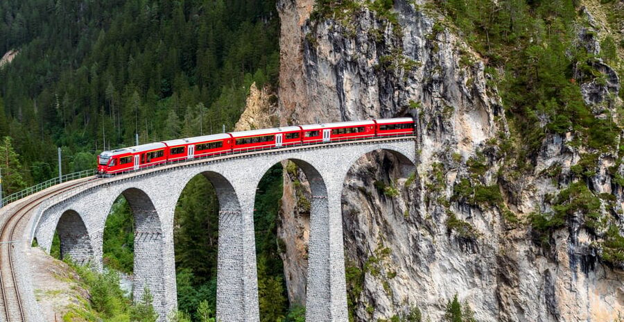 From Milan: Bernina Train Guided Tour to St. Moritz - Starting at Milan Central, Apple Monument to the mountain start line