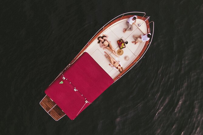 Private Boat Tour on Italian Gozzo on Lake Como - What happens on board: drinks, shoes off, and when wind becomes your main character